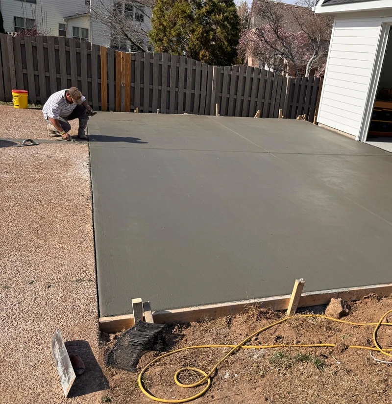 men working on back concrete patio