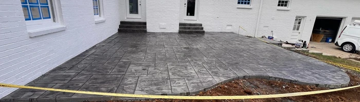 grey stamped concrete patio in backyard